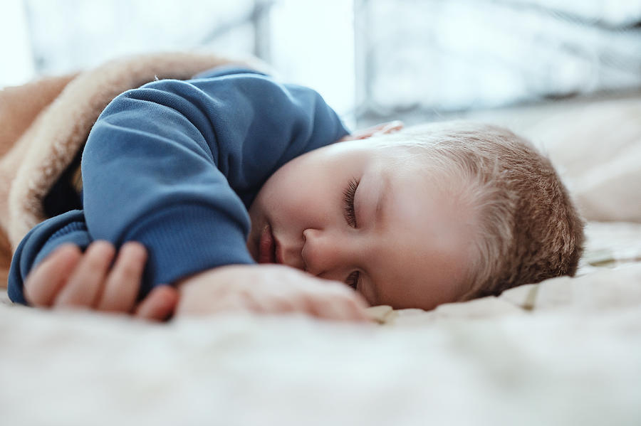 An adorable two years baby boy taking a nap Photograph by Pyrosky