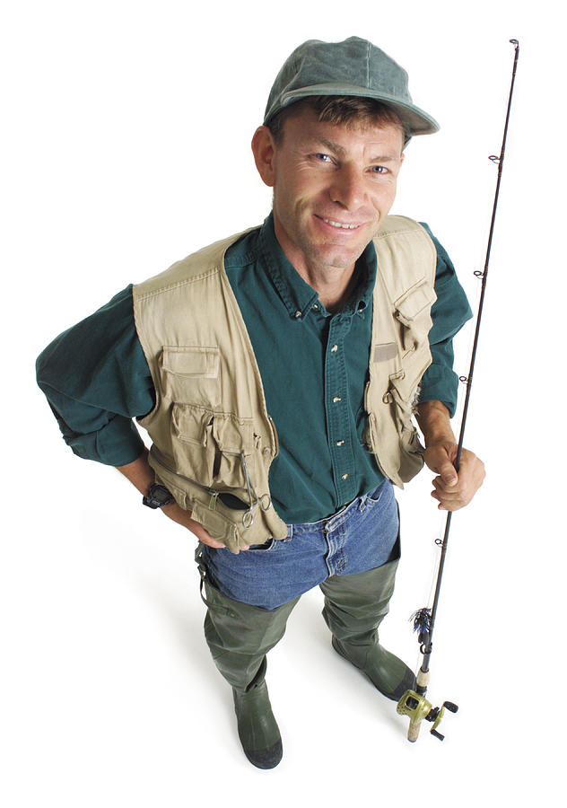 An Adult Caucasian Male Fisherman In A Green Shirt And Tan Fishing Vest Stands Holding His Pole And Smiling As He Looks Up Into The Camera Photograph by Photodisc