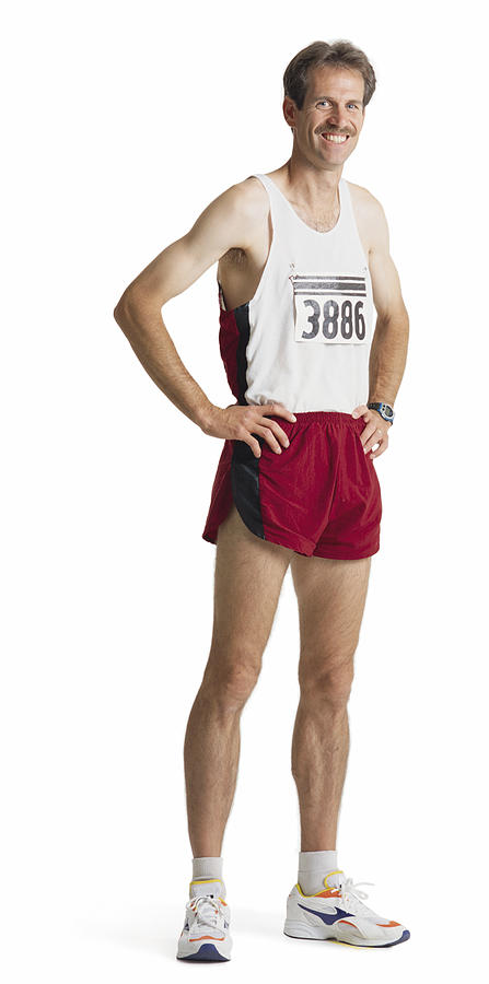An Adult Caucasian Male Marathon Runner In Red Shorts And A White Tank Stands Smiling With Hands On Hips Photograph by Photodisc
