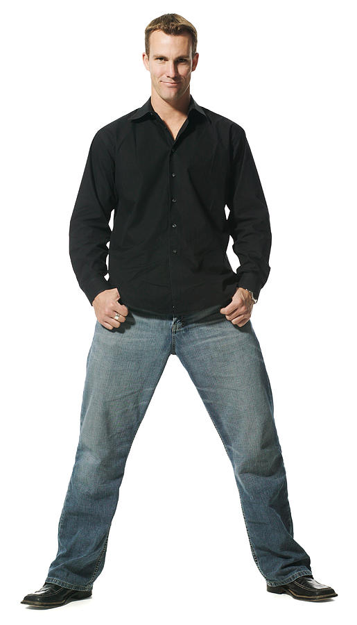 An Adult Caucasian Man In Jeans And A Black Shirt Stands With A Wide Stance And Smiles Photograph by Photodisc