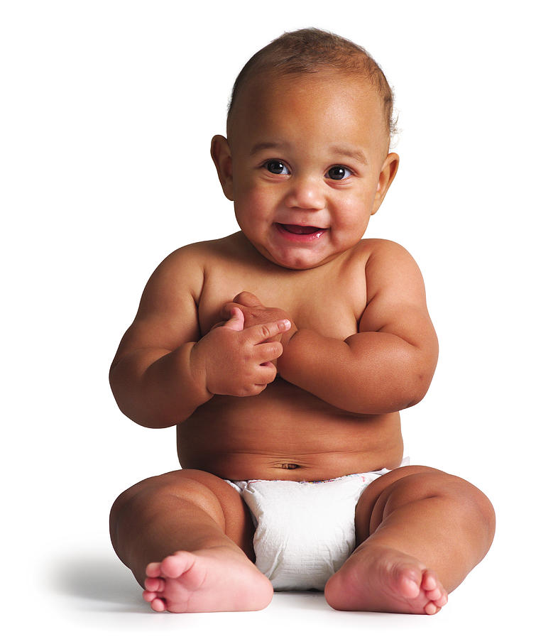 An African American Baby Sits In A Diaper And Smiles Slightly Photograph by Photodisc