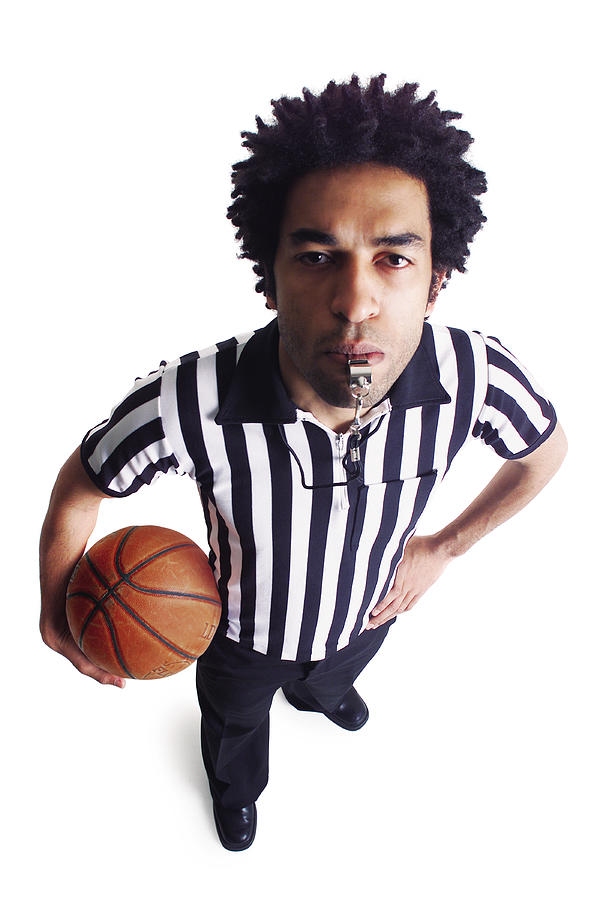 An African American Male Referee Blows His Whistle As He Looks Up At The Camera Photograph by Photodisc