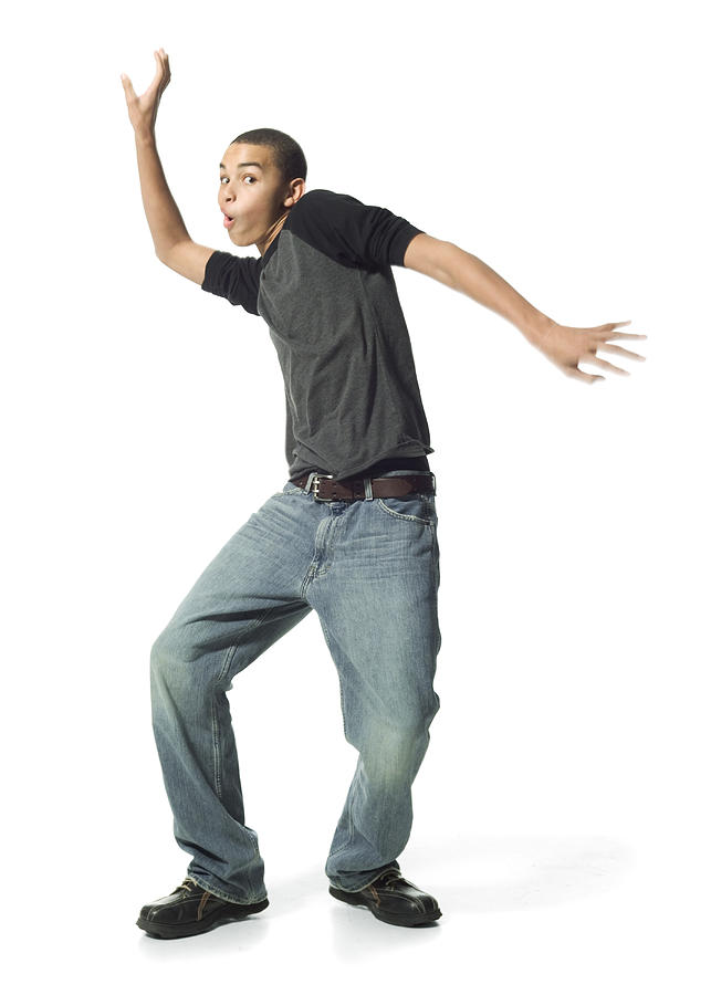 An African American Male Teen In Jeans And A Grey Shirt Does A Funny Dance Photograph by Photodisc