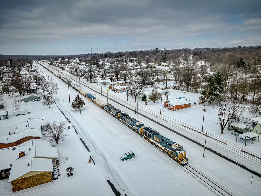 An almost empty CSX Q025 southbound through the snow Photograph by Jim Pearson