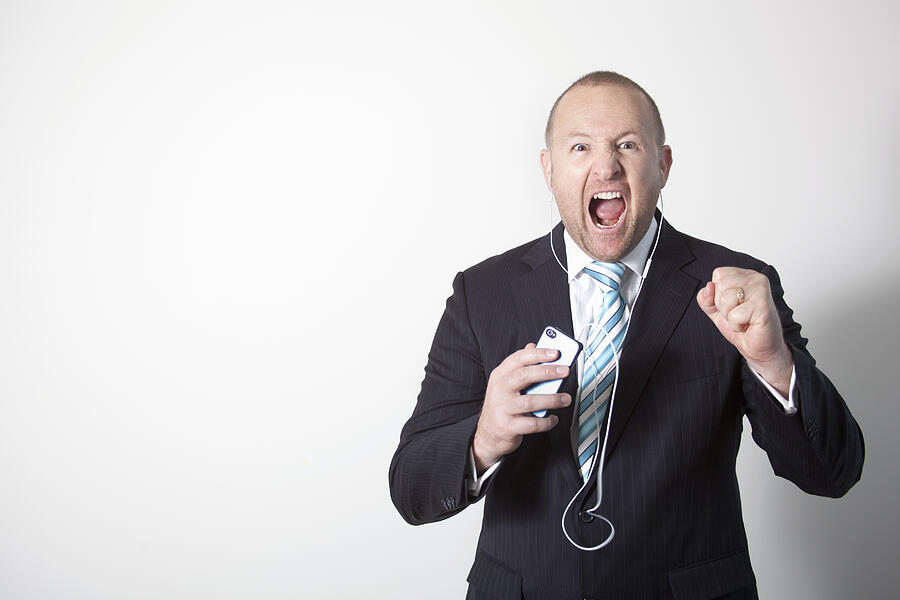 An angry businessman yelling on a smart phone Photograph by Virginia Star