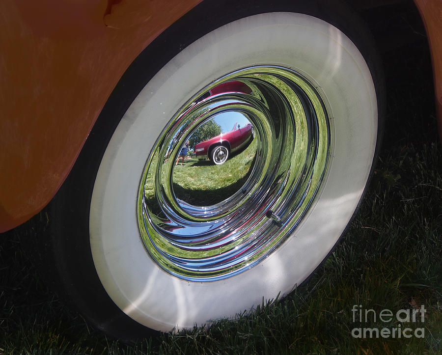 An Antique Red Car Reflected in a Hubcap Photograph by L Bosco