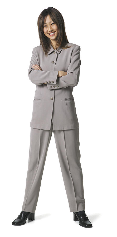 An Asian Business Woman In A Grey Pant Suit Folds Her Arms And Smiles Photograph by Photodisc