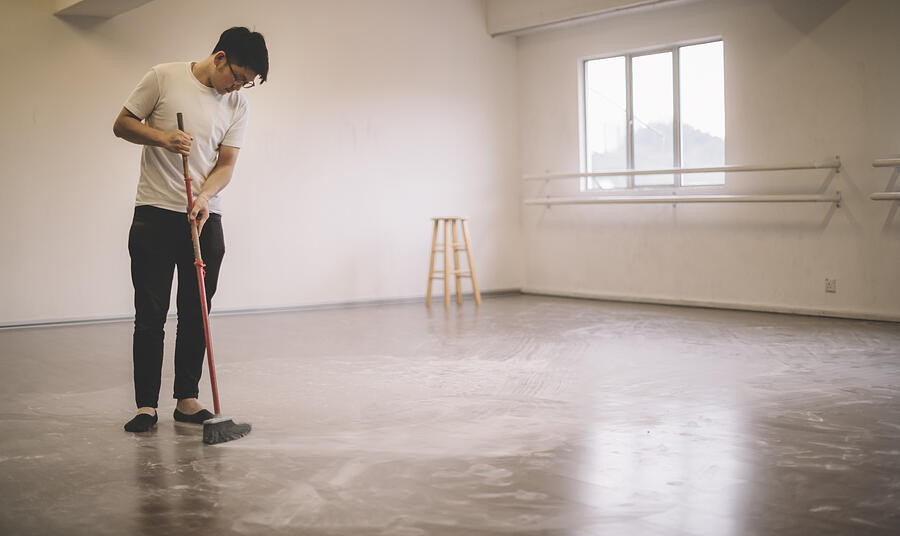 An Asian Chinese Male Dancer Cleaning Up Ballet Dancer Floor Sweeping After Practise With Broom Photograph by Edwin Tan