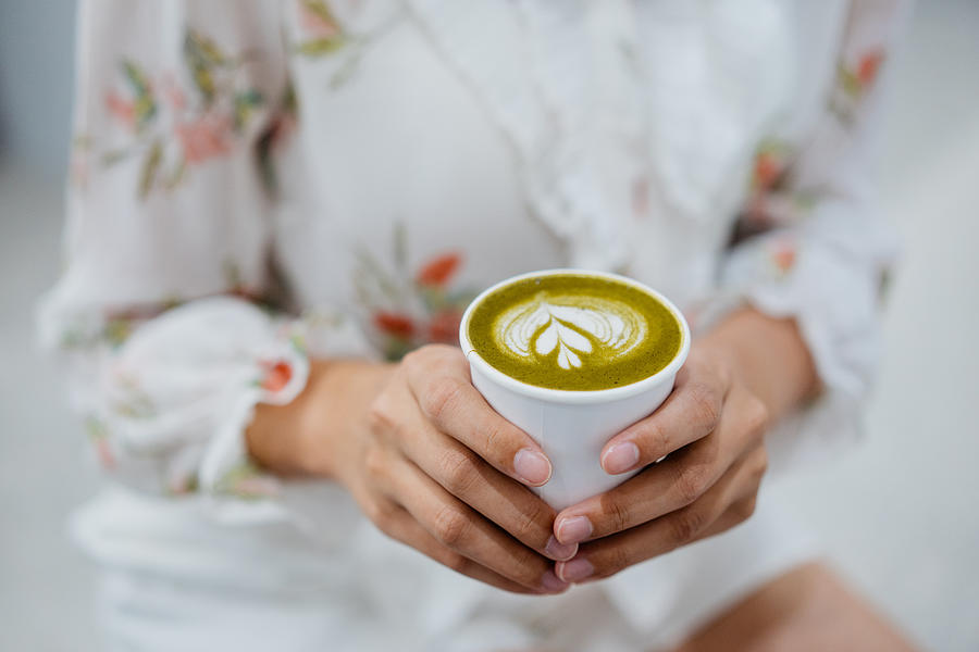 An Asian Chinese woman holding a cup of matcha latte Photograph by Hxyume