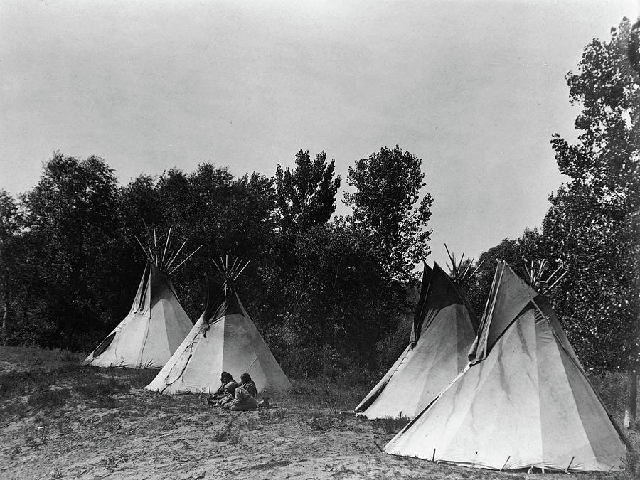 Vintage Photograph - An Assiniboin camp containing four tepees with Indians seated on ground by Edward Curtis