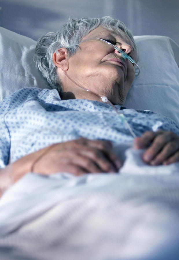 An Elderly Caucasain Woman Lays In A Hospital Bed As She Tries To Recover From An Illness Photograph by Photodisc