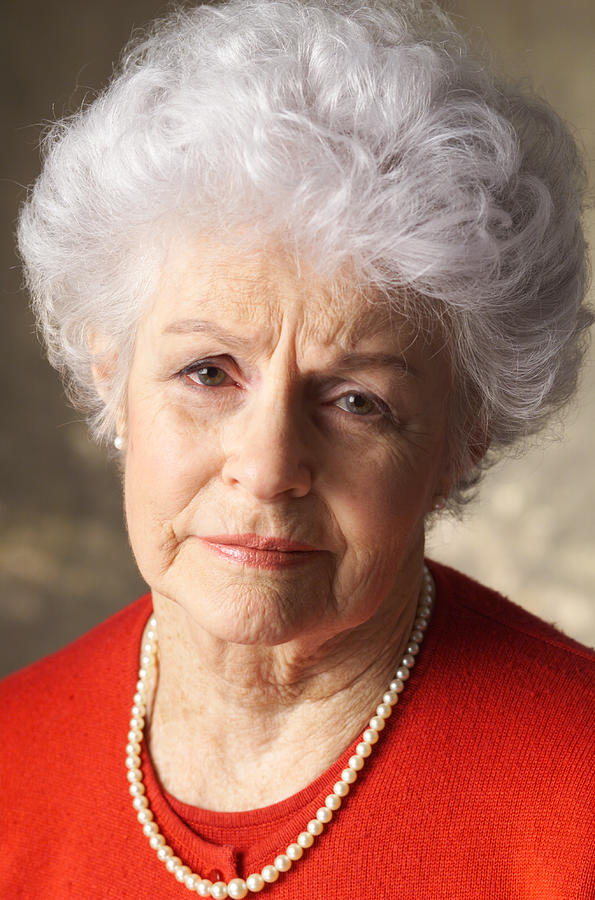 An Elderly Caucasian Woman With Curly White Hair Is Wearing A Red Shirt And Has An Expression Of Sadness Photograph by Photodisc
