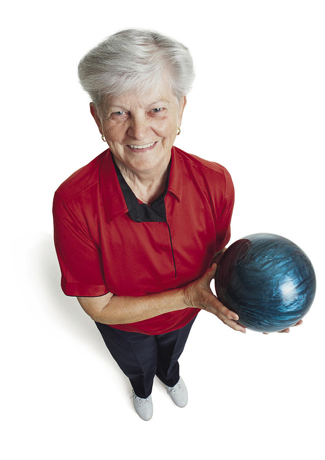 An Elderly Caucasian Woman With White Hair Is Wearing A Red Bowling Shirt And Holding Her Blue Bowling Ball As She Looks Up At The Camera Smiling Photograph by Photodisc