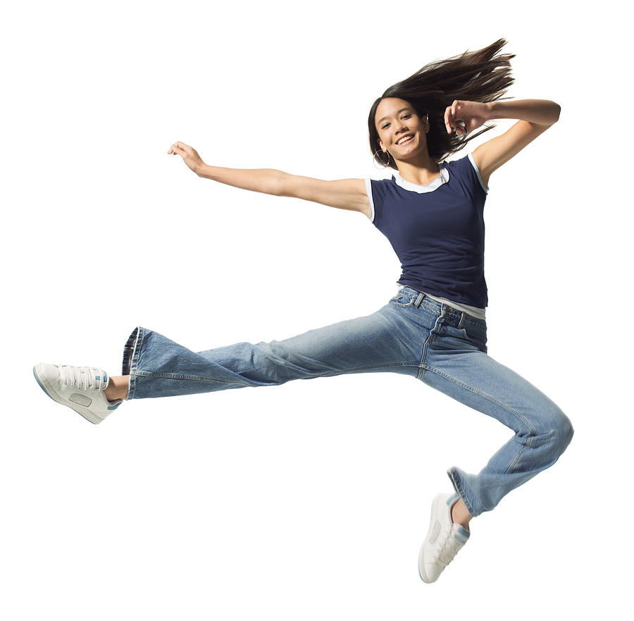 An Ethnic Teenage Female In Jeans And A Blue Tank Top Jumps Through The Air Photograph by Photodisc