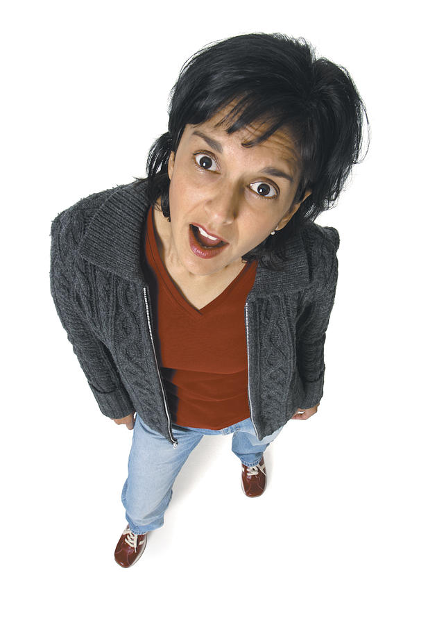 An Ethnic Woman In A Brown Shirt And Grey Sweater Looks Up At The Camera In Shock And Disbelief Photograph by Photodisc