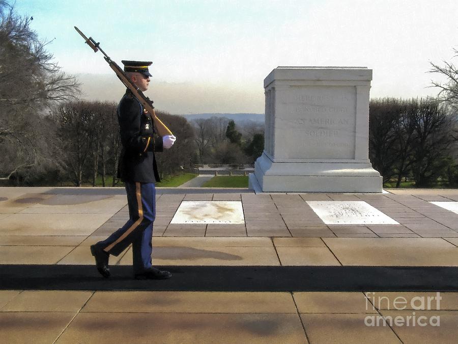 An honor guard sentry guards the Tomb of the Unknowns at Arlington National Cemetery Photograph by William Kuta
