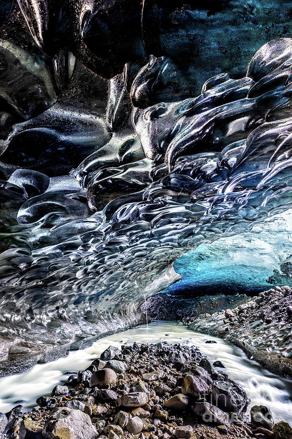 An icy river carries melt water through an ice cave in the glaci Photograph by Jane Rix