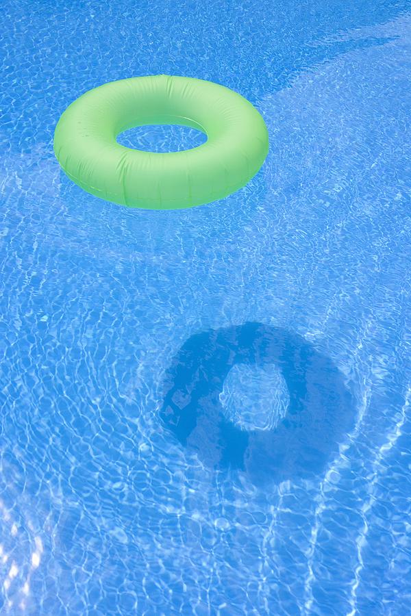 An inflatable ring floating in a swimming pool Photograph by Halfdark