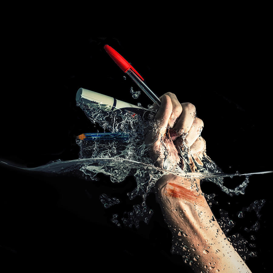 An injured arm rising from water Photograph by bgs Photography