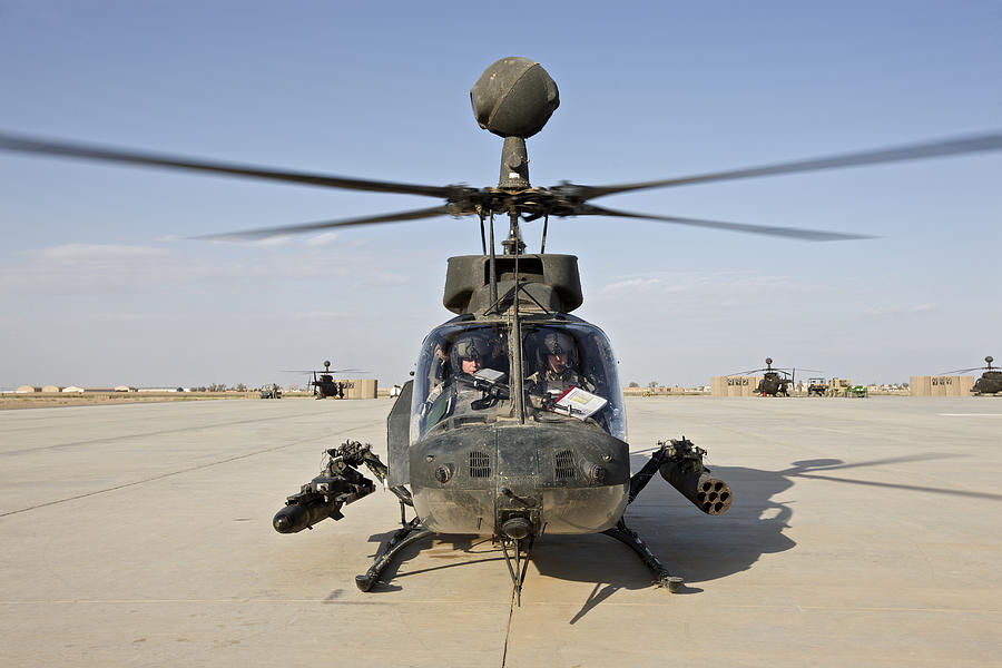 An OH-58D Kiowa helicopter prepares for liftoff from COB Speicher, Tikrit, Iraq, during Operation Iraqi Freedom. Photograph by Terry Moore/Stocktrek Images