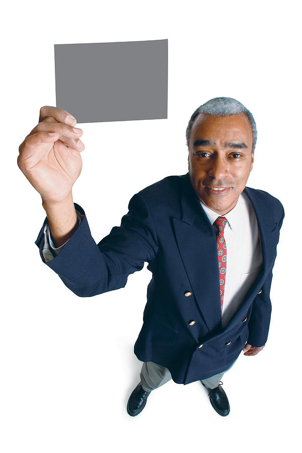 An Older African American Male In A Jacket And Tie Holds Up A  Card As He Smiles Up At The Camera Photograph by Photodisc