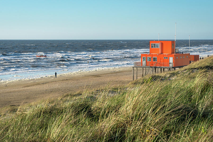 An orange safeguard shed on the beach in the Netherlands Photograph by Anges Van der Logt