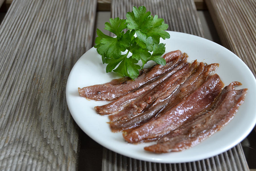 Anchovy fillets on a white plate Photograph by Blanchi Costela