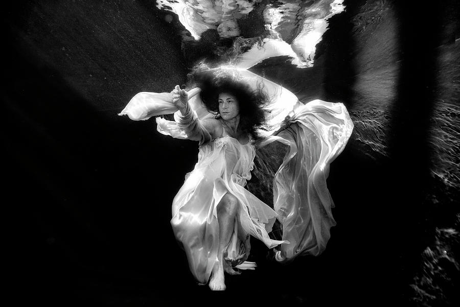Angel floating in the water Photograph by Dan Friend
