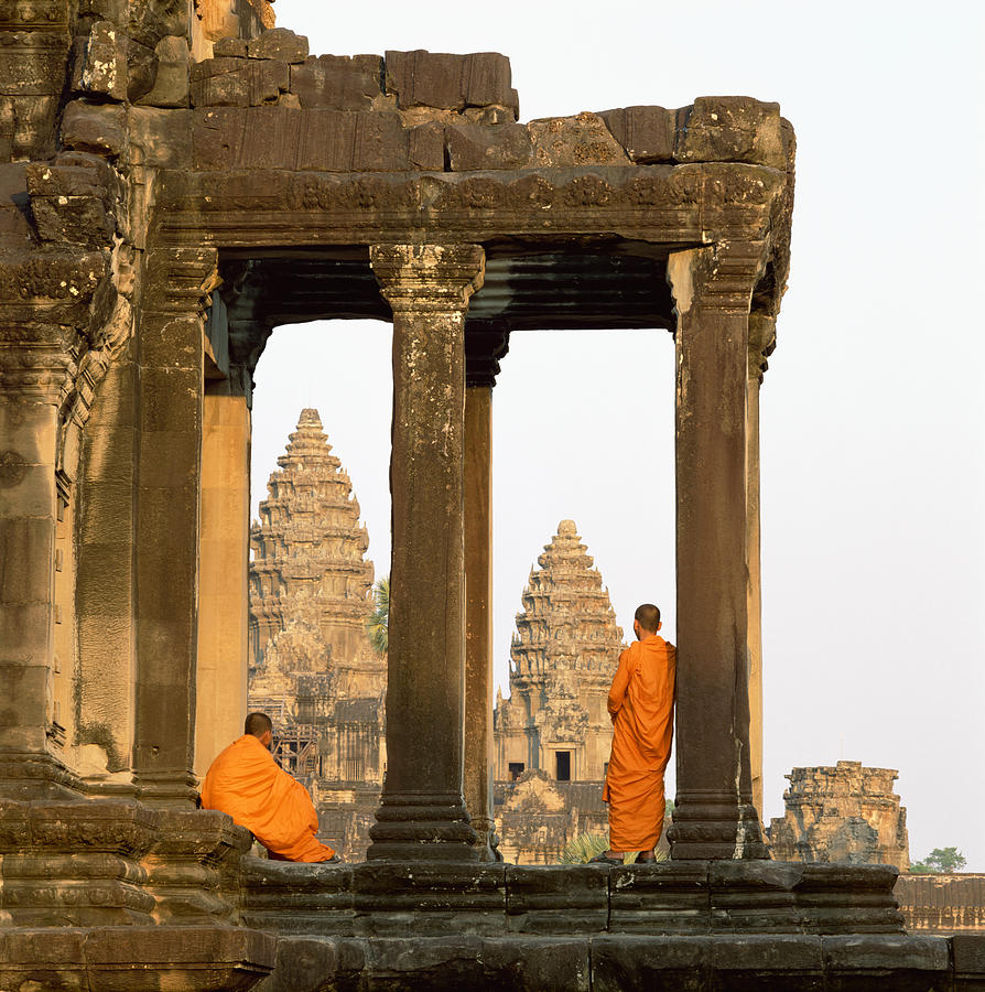 Angkor Wat, Buddhist monks standing amongst ruins Photograph by Martin Puddy Angkor Wat, Buddhist monks standing amongst ruins Photograph by Martin Puddy