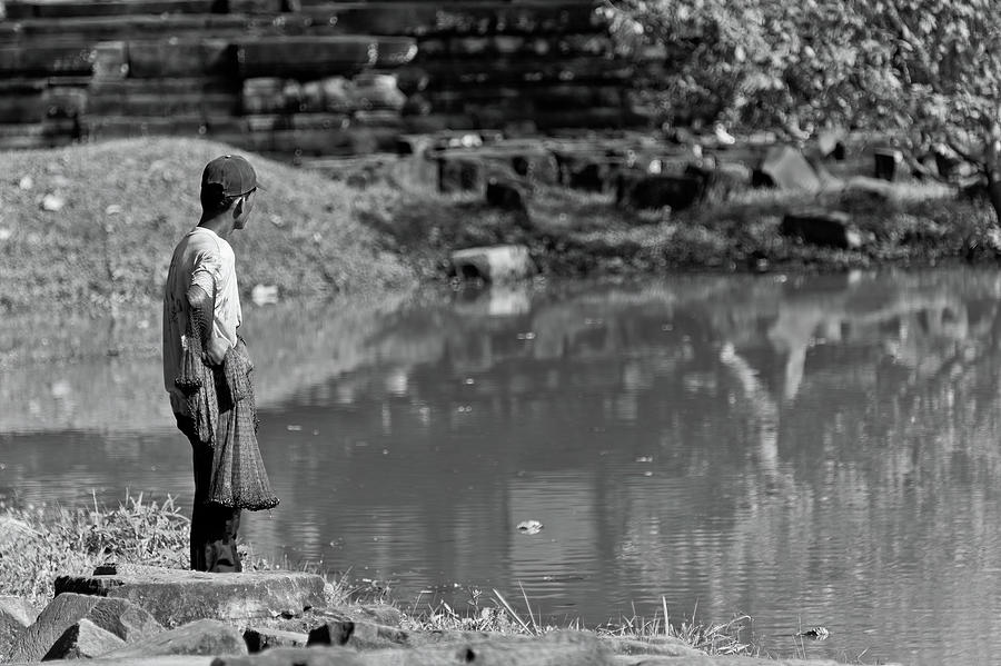 Angkor wats lake fisherman. Cambodia  Photograph by Lie Yim
