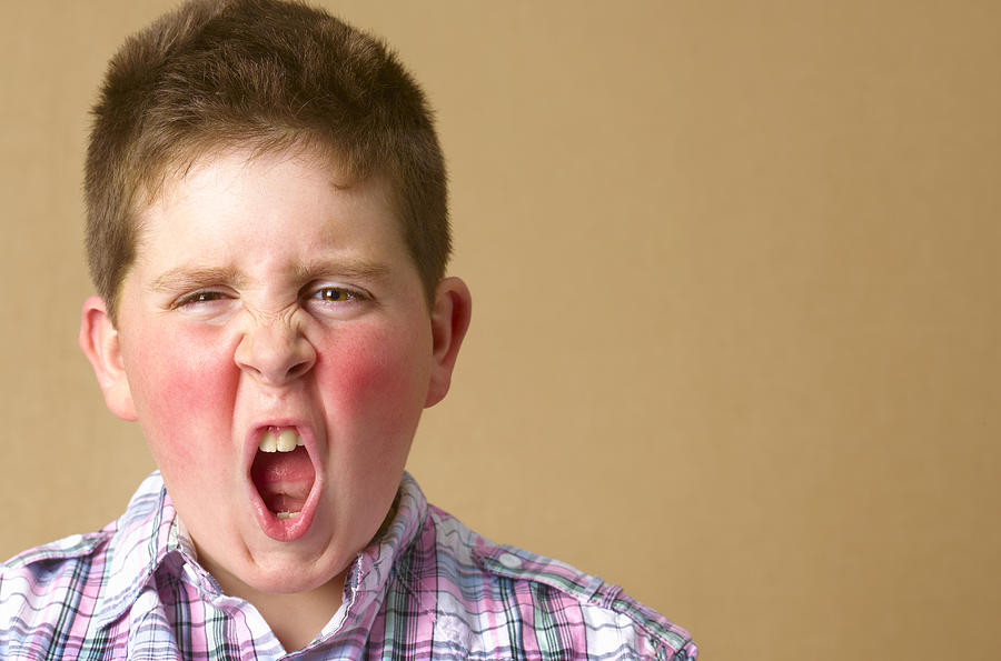 Angry 12 year old boy shouting Photograph by Peter Dazeley