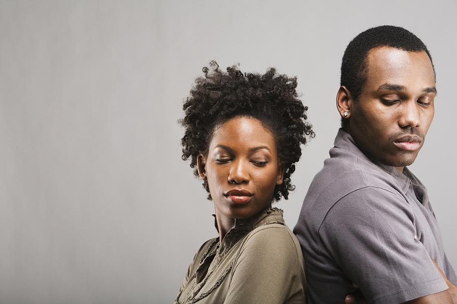 Angry African American couple standing back to back Photograph by Hill Street Studios