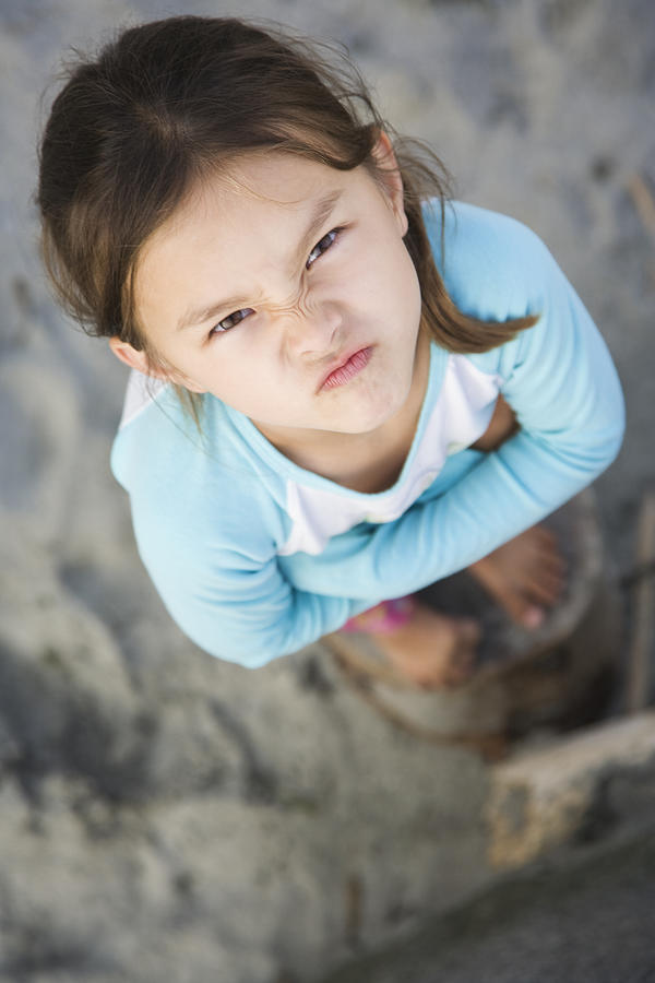 Angry Asian girl frowning Photograph by Don Mason