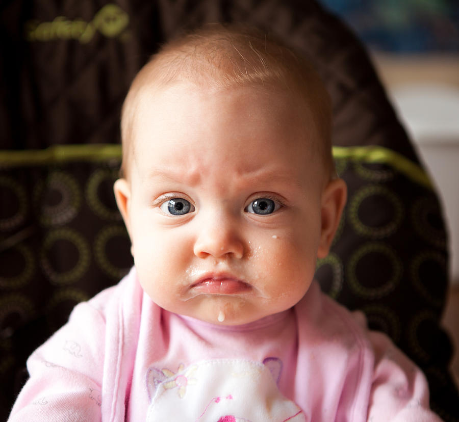Angry baby girl with oatmeal on face Photograph by Photographs by Peter Thornton