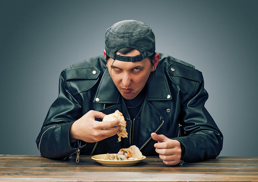 Angry man eating Photograph by Slonov