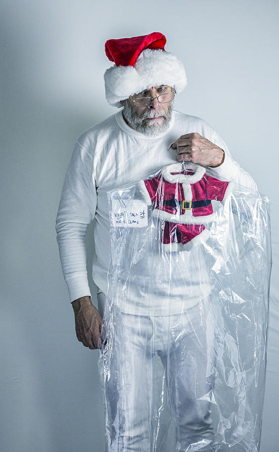 Angry Santa Claus Holding Shrunken Dry Cleaned Santa Costume Photograph by Willowpix