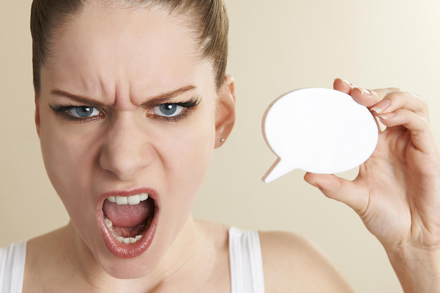 Annoyed Woman Holding Speech Bubble And Shouting Photograph by MachineHeadz