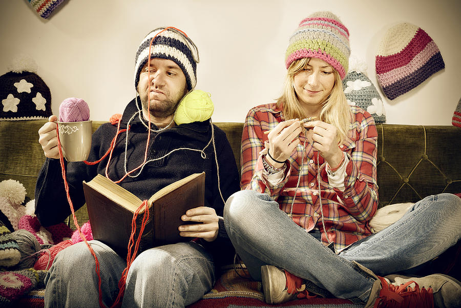 Annoying young knitter woman couple portrait on couch Photograph by Ilbusca