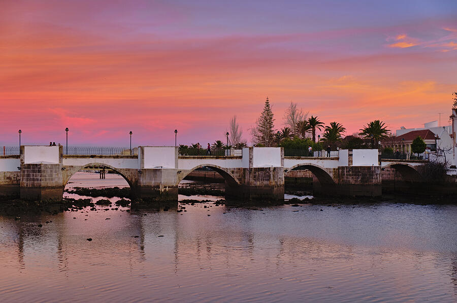 Antique bridge of Tavira during twilight. Portugal Photograph by Angelo DeVal