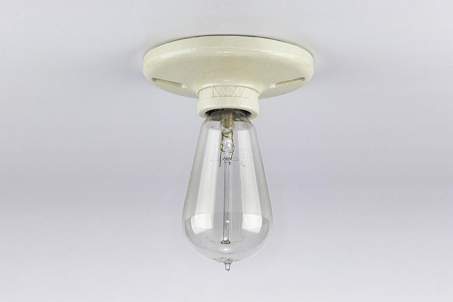 Antique Light bulb in porcelain socket Photograph by Jack R Perry