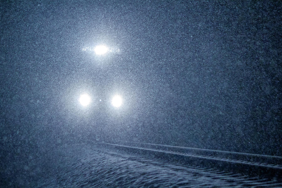 Approaching Headlights In The Snow Photograph