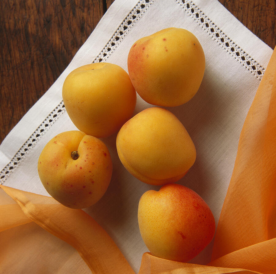 Apricots On White Cloth Photograph by Eising