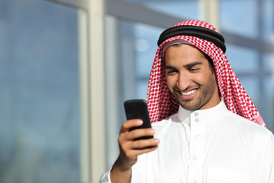 Arab saudi businessman working  with his phone Photograph by AntonioGuillem