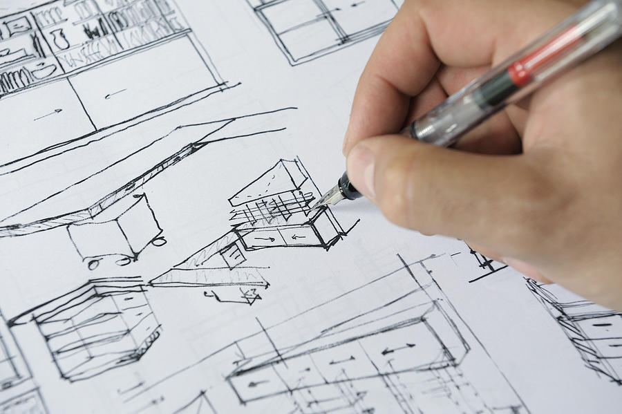 Architects hand sketching interior plans Photograph by David Malan