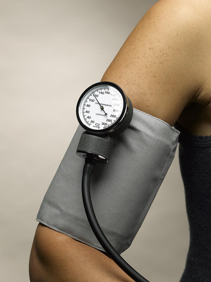 Arm with blood pressure cuff Photograph by Jeffrey Hamilton