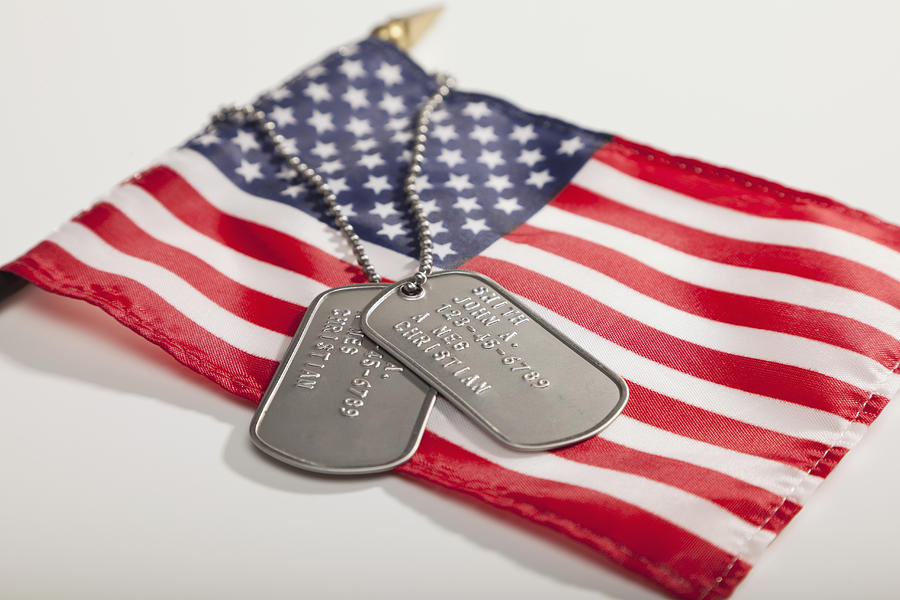 Army dog tags on Stars and Stripes flag Photograph by Vstock LLC