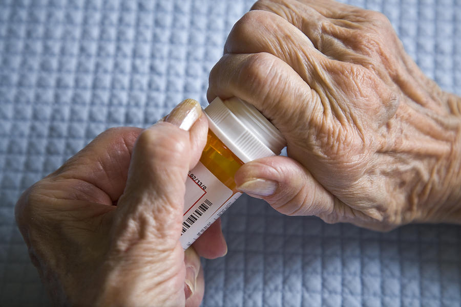 Arthritis Hands Trying To Open Prescription Medicine Pill Bottle Photograph by Dszc