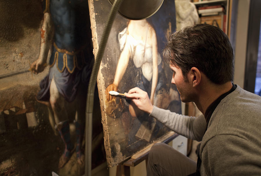 Artist Restoring A Painting In His Studio Photograph by Kathrin Ziegler