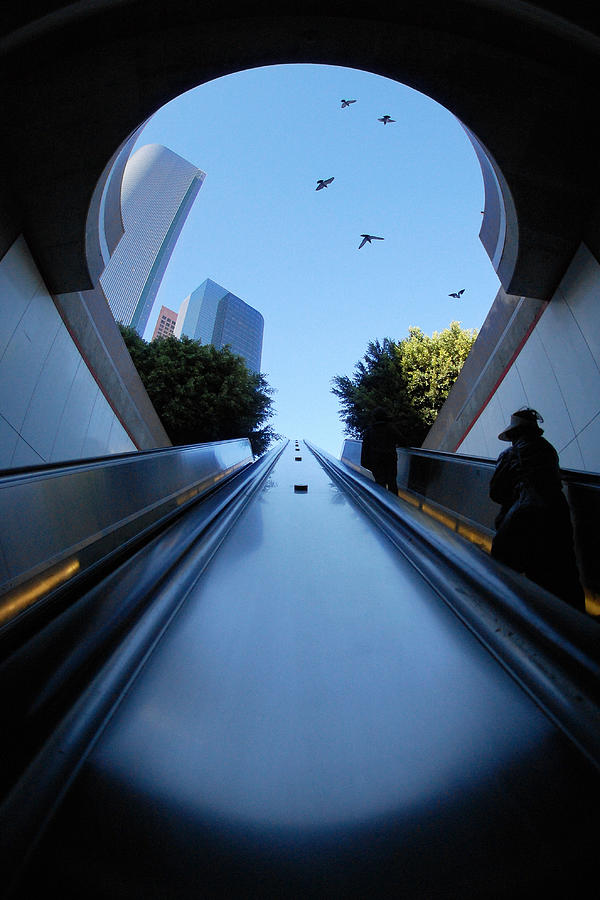 Ascending -- Woman Riding Escalator in a Subway Station in Los Angeles, California Photograph by Darin Volpe