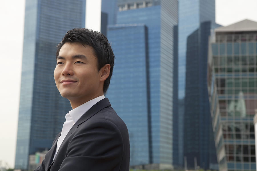 Asian Businessman smiling in city Photograph by Eternity in an Instant